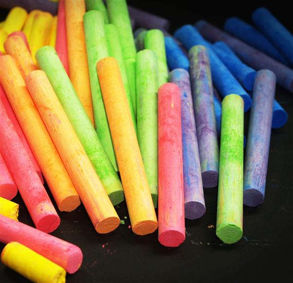  Colored chalk fanned across black background